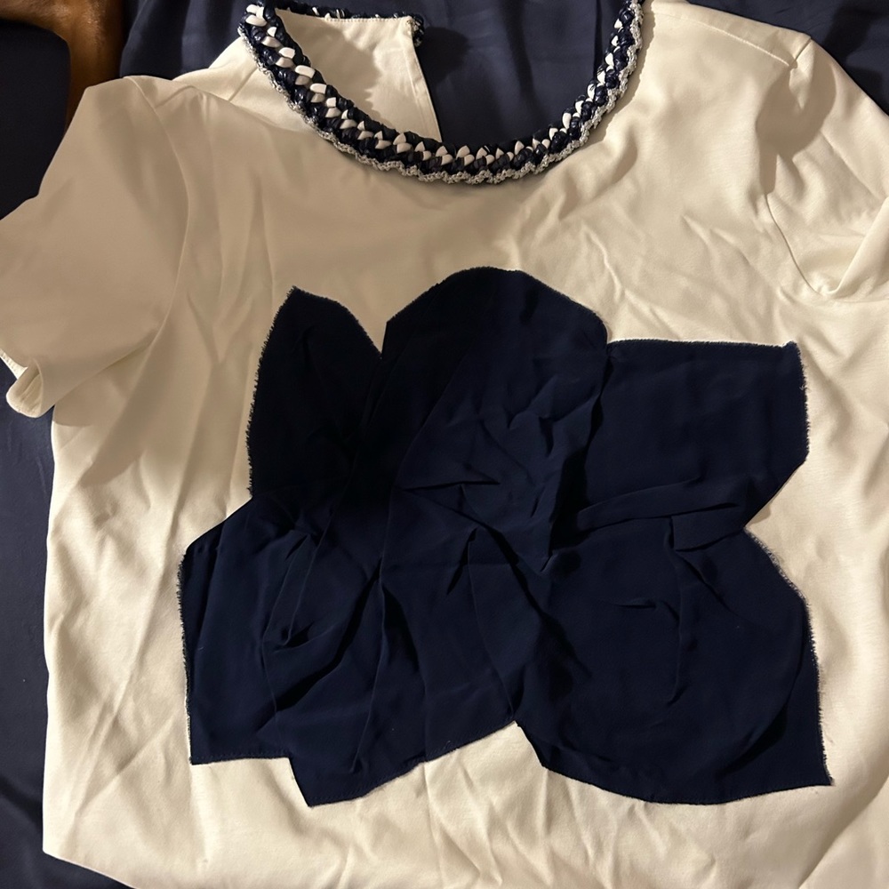 Chanel top with blue flower detail. Note edges in last picture as original